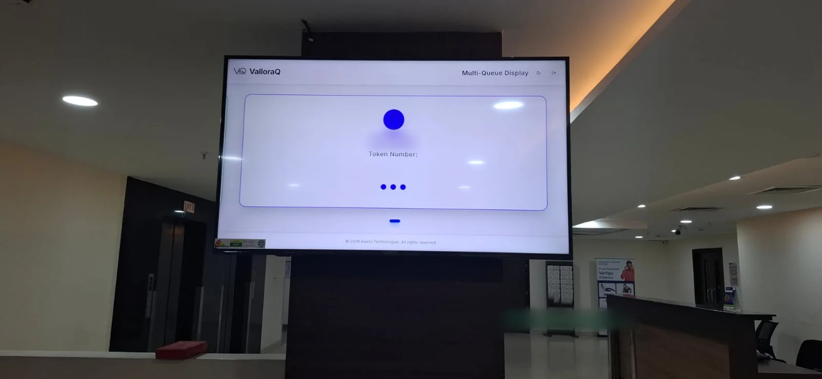 Close-up of the ValloraQ Multi-Queue Display on a large TV in the hospital hall, waiting for the next token
